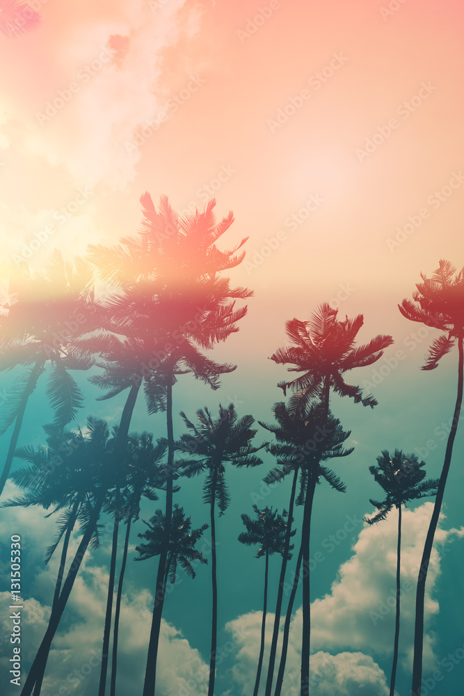 Naklejka premium Coconut palm trees on tropical ocean beach, vintage toned and retro color stylized with film light leak