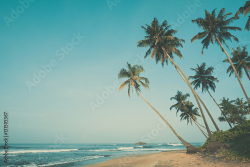 Fototapeta Naklejka Na Ścianę i Meble -  Tropical beach with palm trees, vintage color stylized