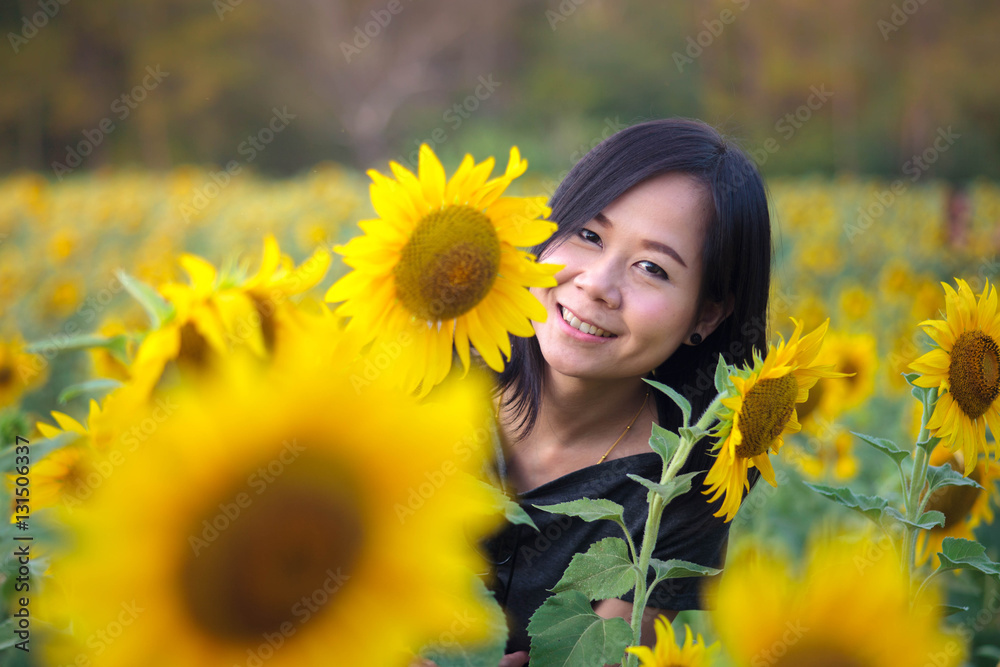 Cute asia girl in the field full of sunflowers Cute asia girl in the field full of sunflowers