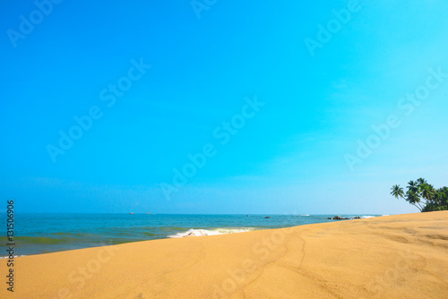 Fototapeta Naklejka Na Ścianę i Meble -  Beautiful beach with sand dunes on tropical island with coconut palm trees and clean sand at clear sunny summer day