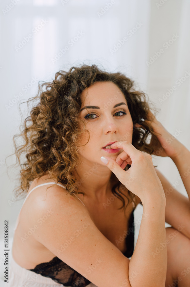 Sexy woman in bed in the morning showing her beautiful body. She doesn't wants to wake up. Awaken with natural light in her bedroom and covered with the bed sheets. Sexy woman in bed in the morning showing her beautiful body. She doesn't wants to wake up. Awaken with natural light in her bedroom and covered with the bed sheets.