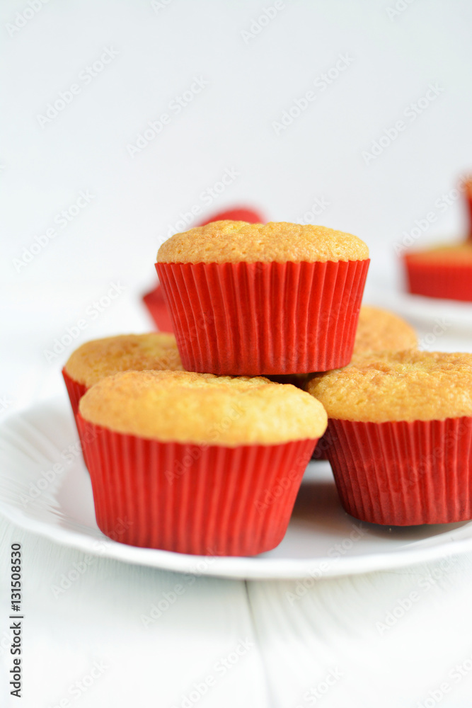 Homemade cupcakes in a white plate on white background Homemade cupcakes in a white plate on white background