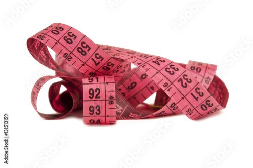 Measuring pink ribbon isolated on white background photo