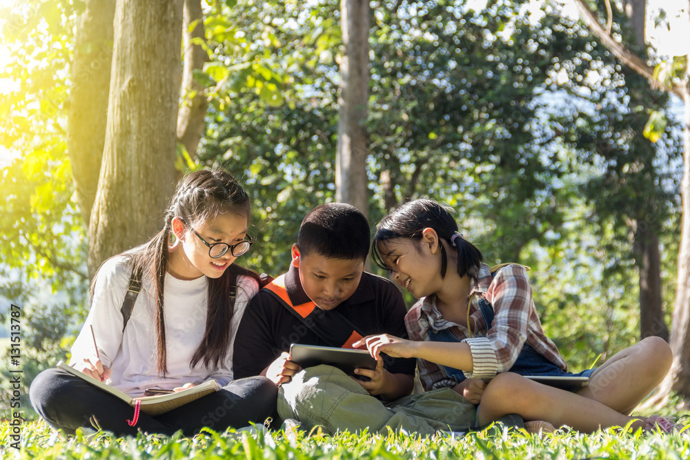 Child fun to play tablet in the park