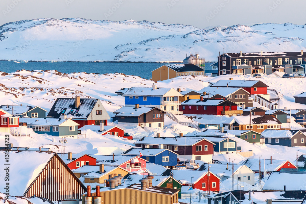 Fototapeta premium Nuuk city covered in snow with sea and mountains in the backgrou