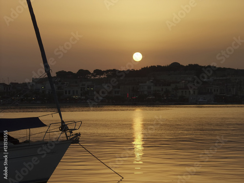 Sunset in Rethymno, Crete. Yacht silhouette in the marina.