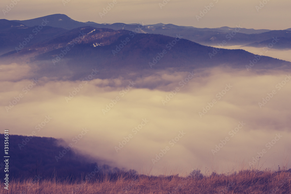 Clouds float among hills in the winter mountains Clouds float among hills in the winter mountains