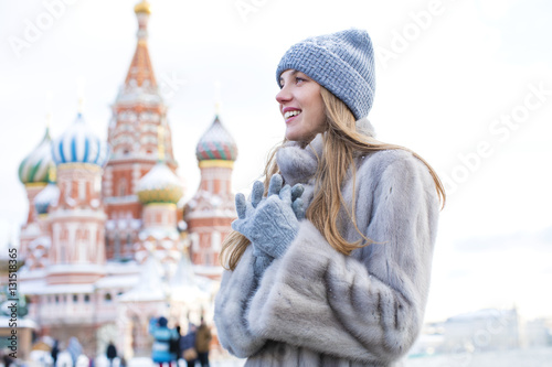 Photography Young woman in a blue knitted hat and gray mink coat