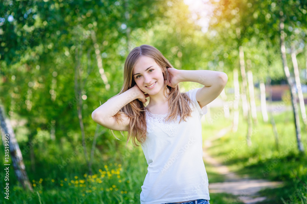 smiling young woman in the Birch Grove in spring