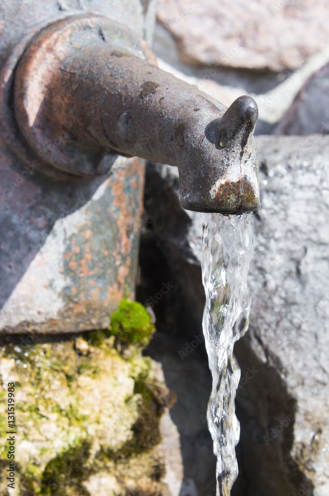 Old rusty water tap on cracked concrete wall Old rusty water tap on cracked concrete wall