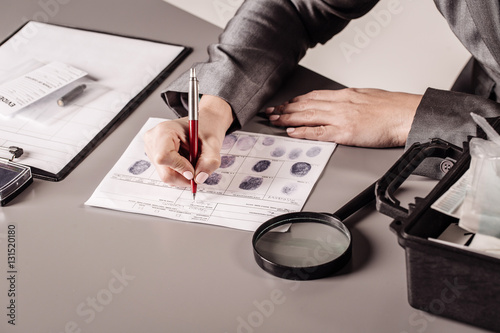 Detective expert writes data into the fingerprint  table photo