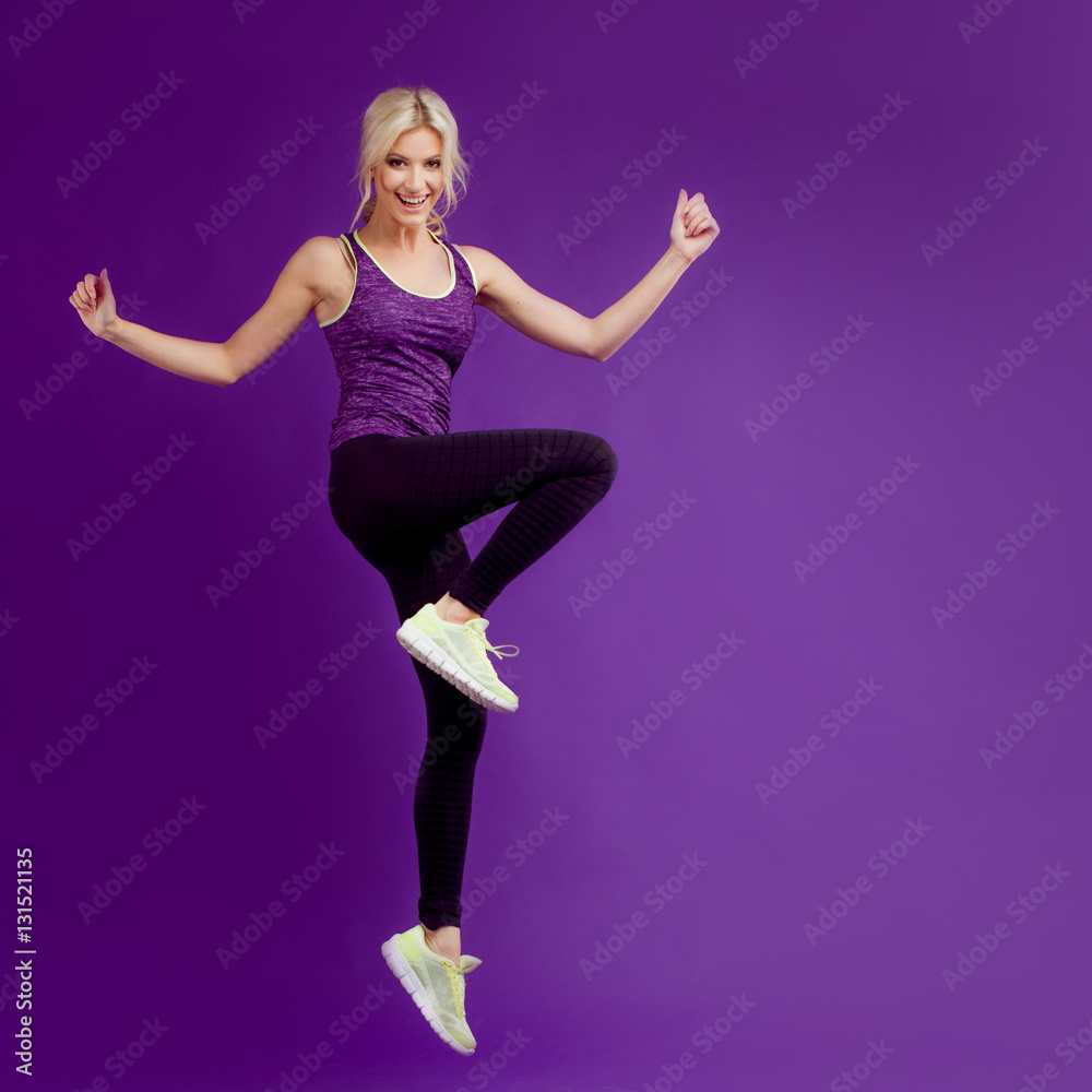 Beautiful young girl in a pose runner. Studio background, purple Beautiful young girl in a pose runner. Studio background, purple