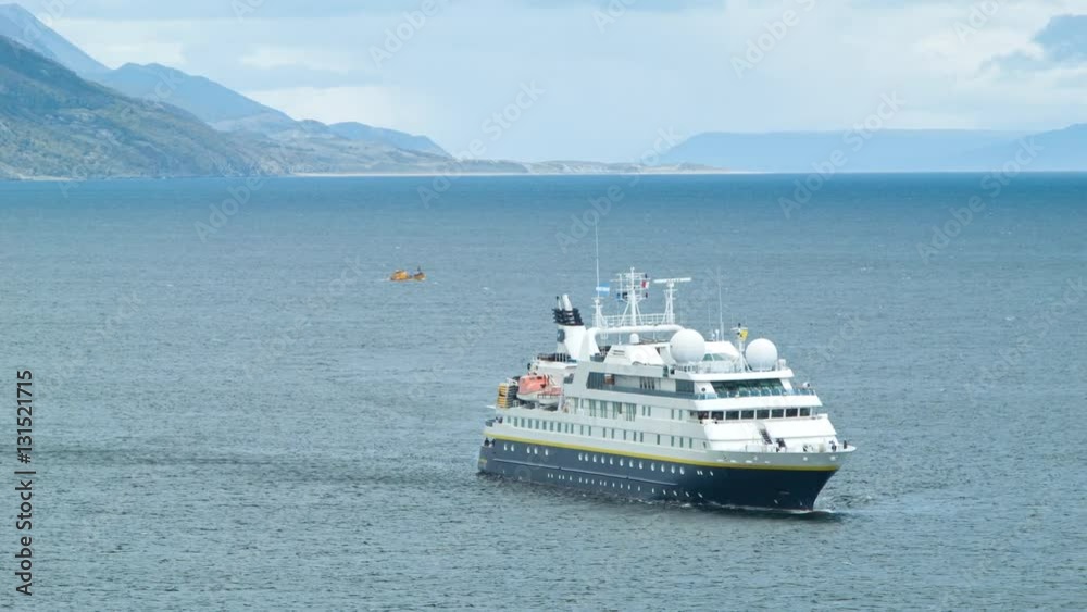 Unmarked Antarctica Explorer Boat Arriving from the Beagle Channel into the Ushuaia Harbor in Argentina at the Southernmost City of the South American Continent Unmarked Antarctica Explorer Boat Arriving from the Beagle Channel into the Ushuaia Harbor in Argentina at the Southernmost City of the South American Continent