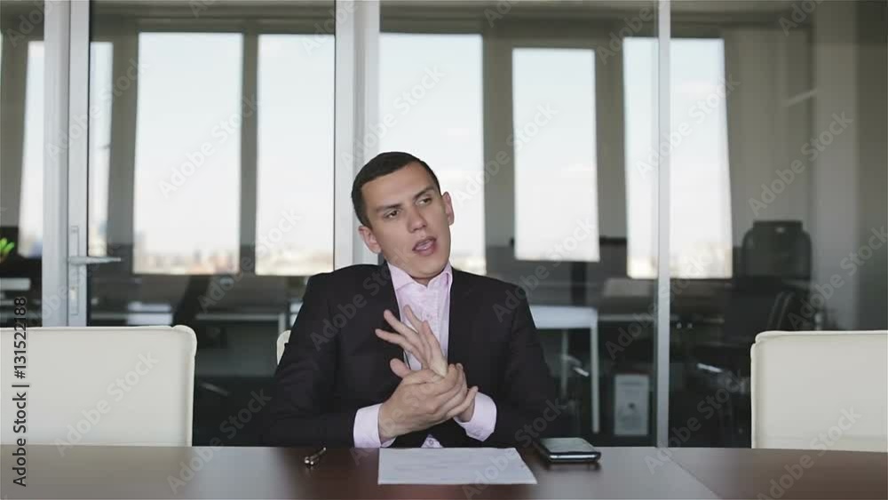 Young businessman signs a contract in the office. Young businessman signs a contract in the office.