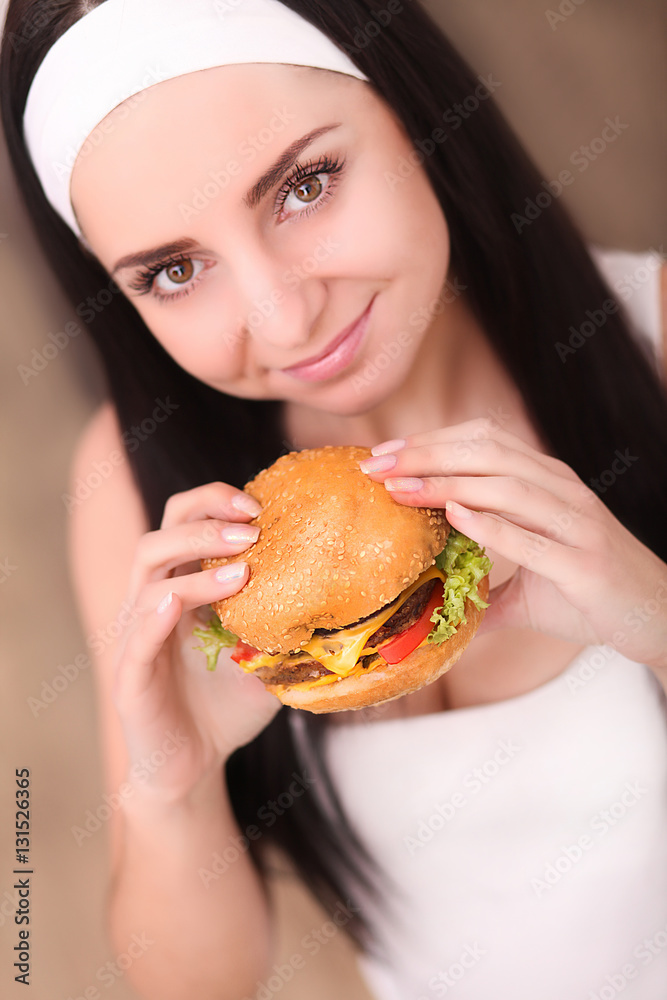 Closeup on teenager girl eating burger Closeup on teenager girl eating burger