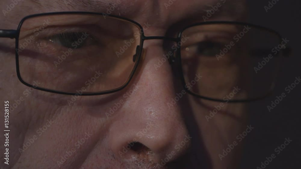elderly man's eyes with glasses looking at a computer monitor elderly man's eyes with glasses looking at a computer monitor