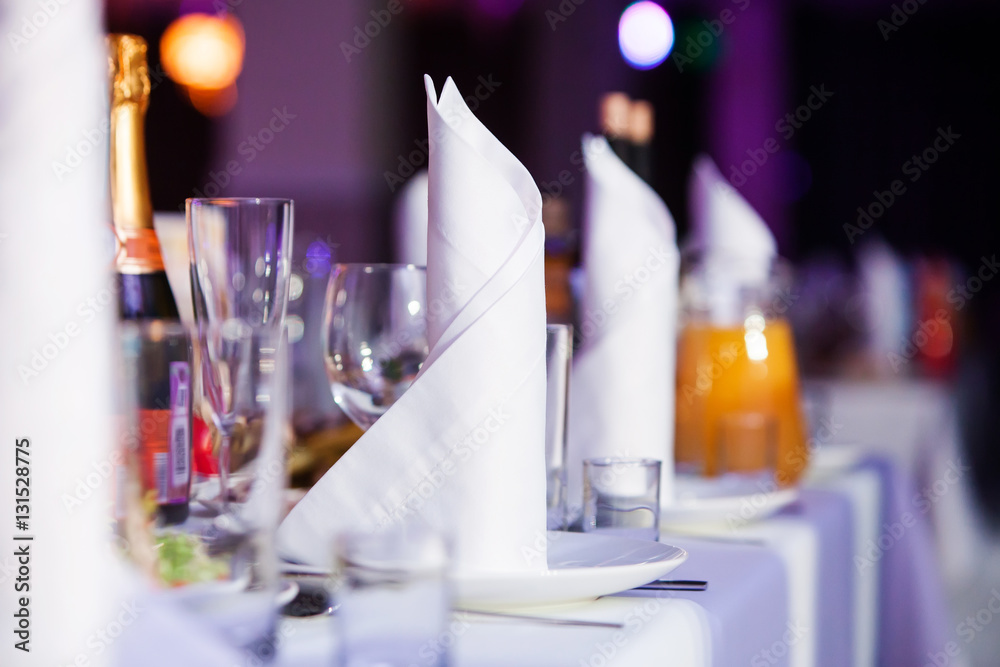Restaurant table with glasses and napkins Restaurant table with glasses and napkins