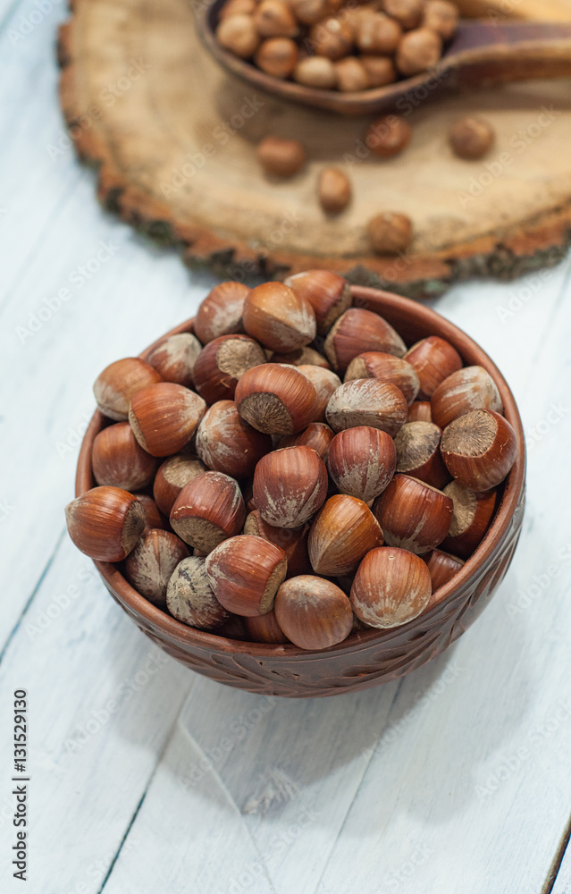 hazelnuts in the shell in brown clay bowl hazelnuts in the shell in brown clay bowl