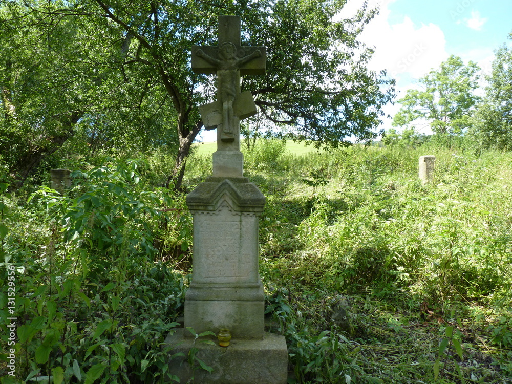 Old Orthodox cemetery with tombstones and stone cross.