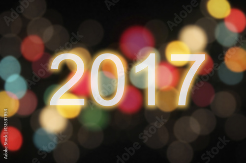 Happy New Year 2017 written with Sparkle firework and colorful lights bokeh background