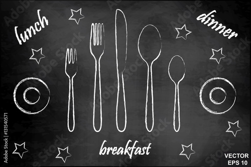 A set of cutlery on a chalkboard. Knife, fork and spoon.