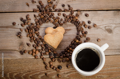 The cup of coffe and two cookies-heart