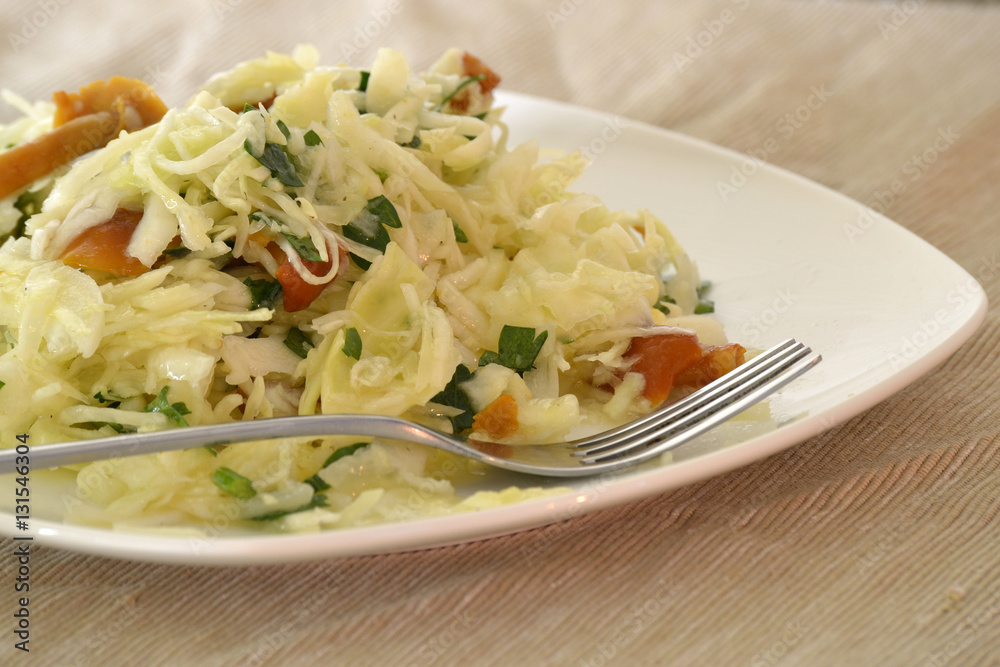 Salad with cabbage and mushrooms on a white plate Salad with cabbage and mushrooms on a white plate