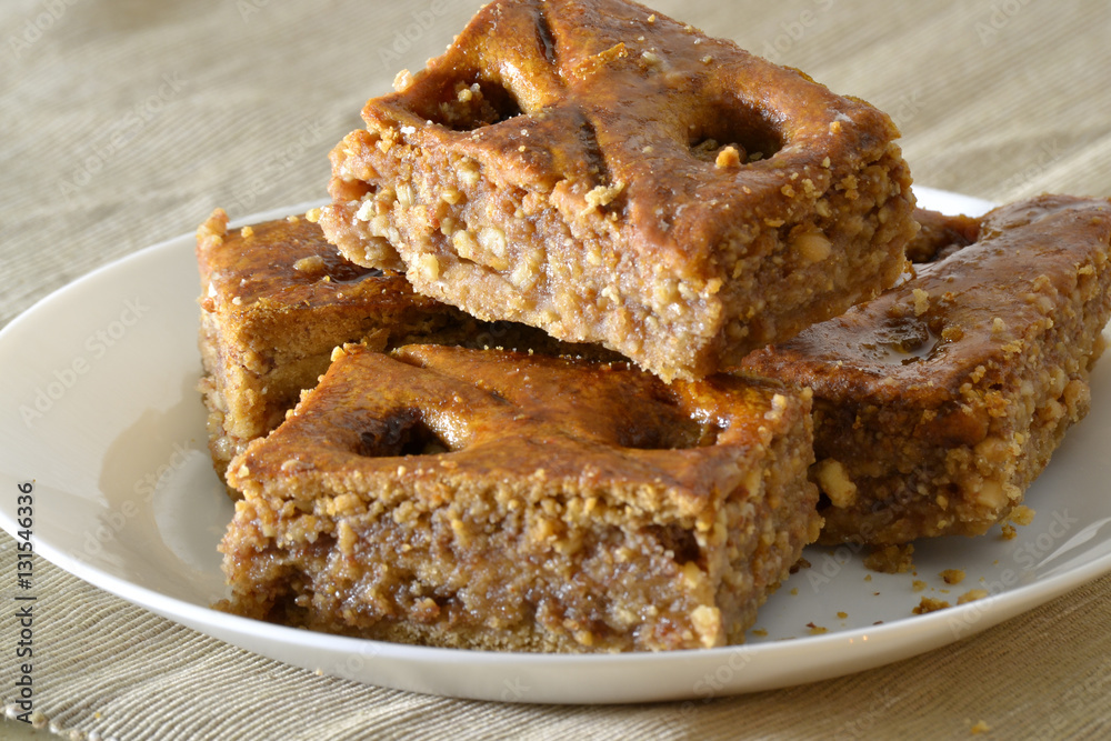 Turkish baklava with walnuts on a white plate Turkish baklava with walnuts on a white plate