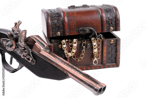Wooden box with decorations and old gun pirates