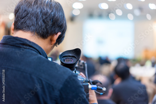 Photographers are making news in the meeting. photo