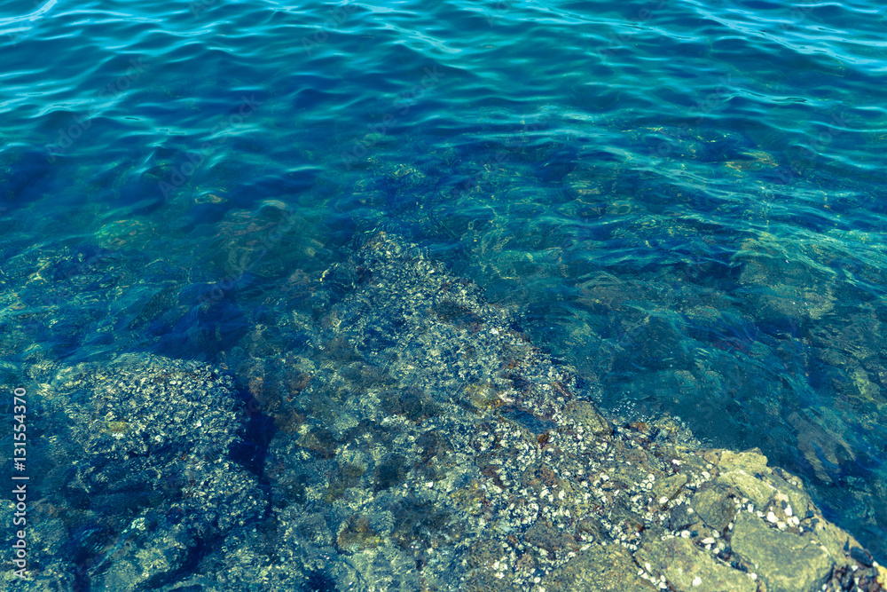 The rocks along the blue ocean waters.