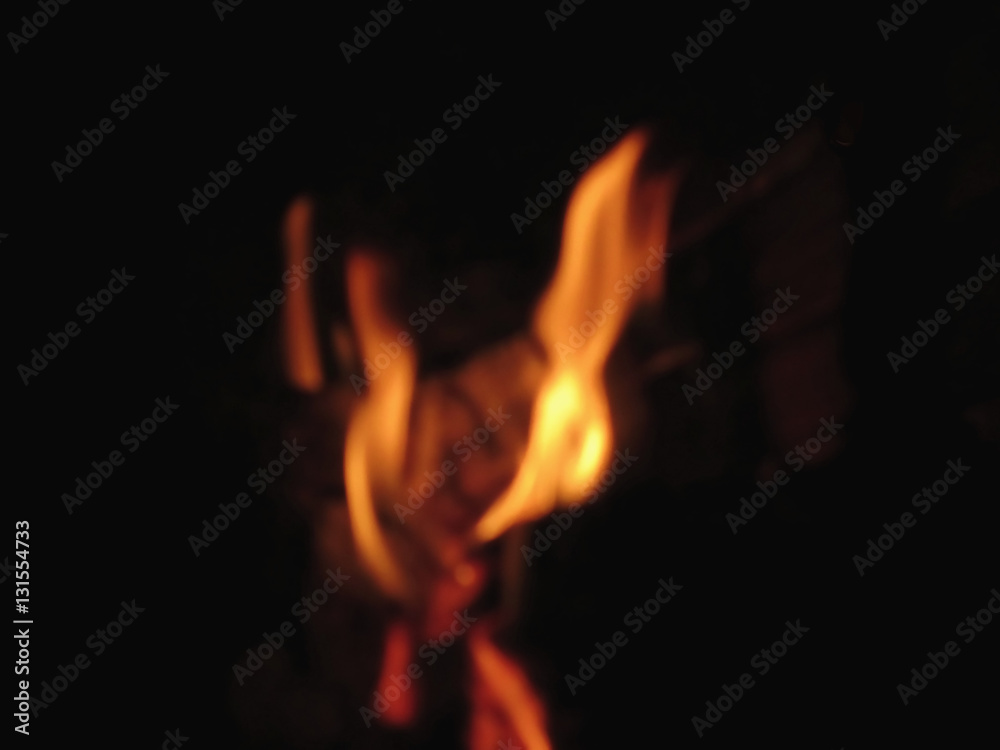 Blurred flames in a burning fireplace on black background Blurred flames in a burning fireplace on black background