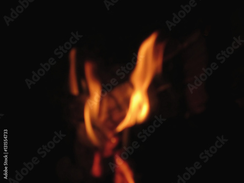 Blurred flames in a burning fireplace on black background