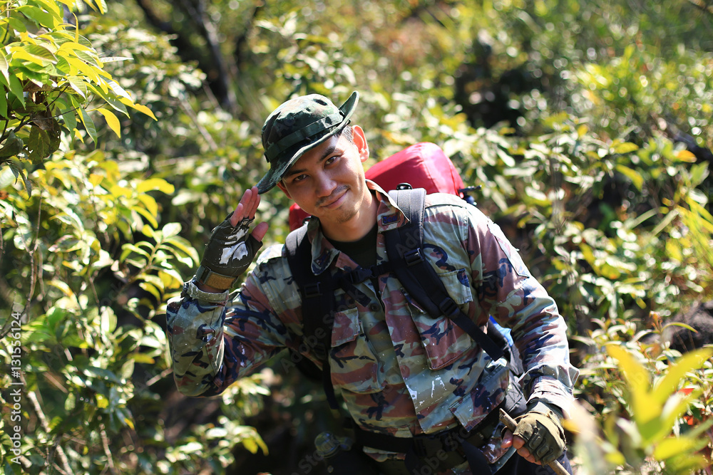 Man Traveler with backpack trekking in forest, Hikers trekking 
with backpacks in forest
