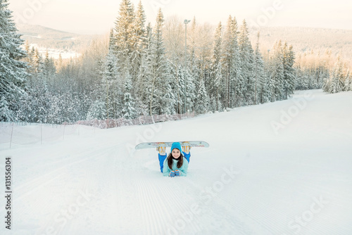 Girl with a snowboard on the ski slope
