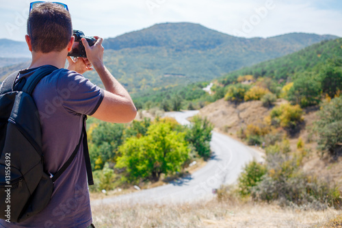 Young man photographing mountain