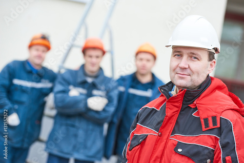 team of construction workers technicians with foreman in front