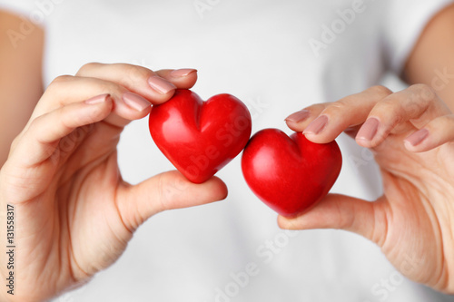 Woman holding red hearts in hands  closeup