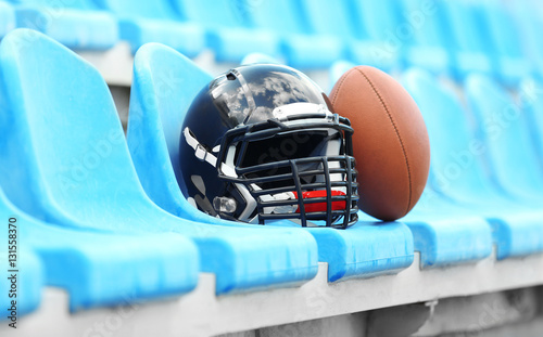 Rugby helmet with ball on stadium chair