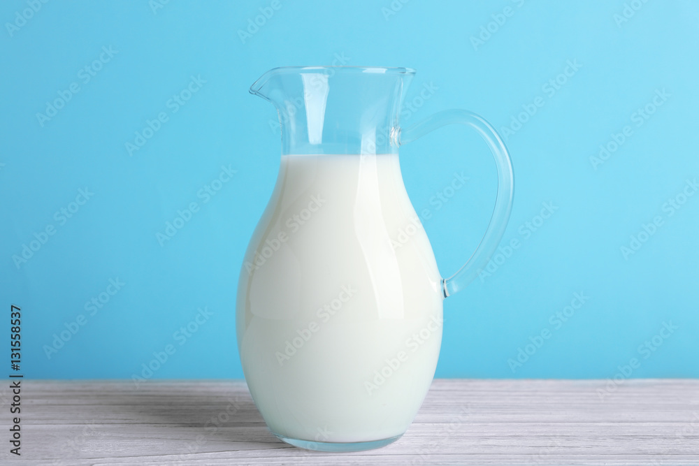 Jug of milk on white wooden table, closeup Jug of milk on white wooden table, closeup