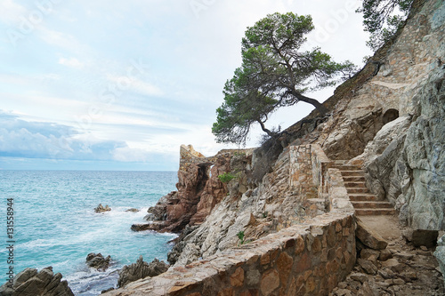 Stairs of ancient fortress on cliff near sea
