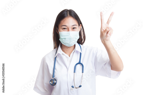 Young Asian female doctor show victory sign.