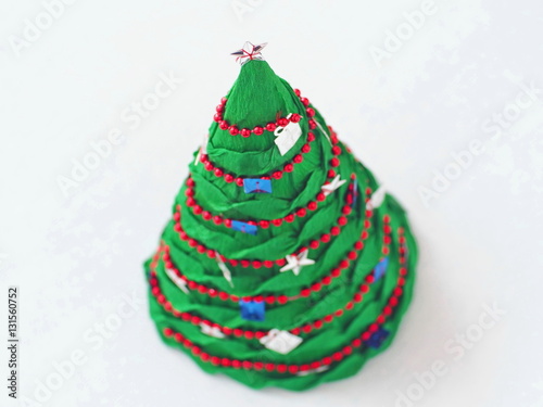 Handmade paper Christmas tree. Holiday handicraft. Top view. Selective focus.