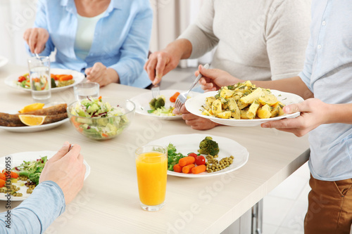 Family having lunch in kitchen, closeup