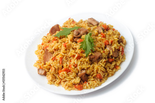 pilaf with meat and vegetables in a white plate