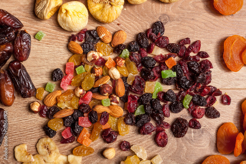 Dried fruits and nuts on wooden background