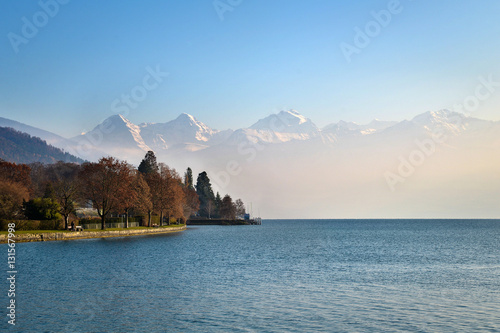 Eiger monch jungfrau at dawn vacation in autums in Switzerland From thun town, Switzerland photo