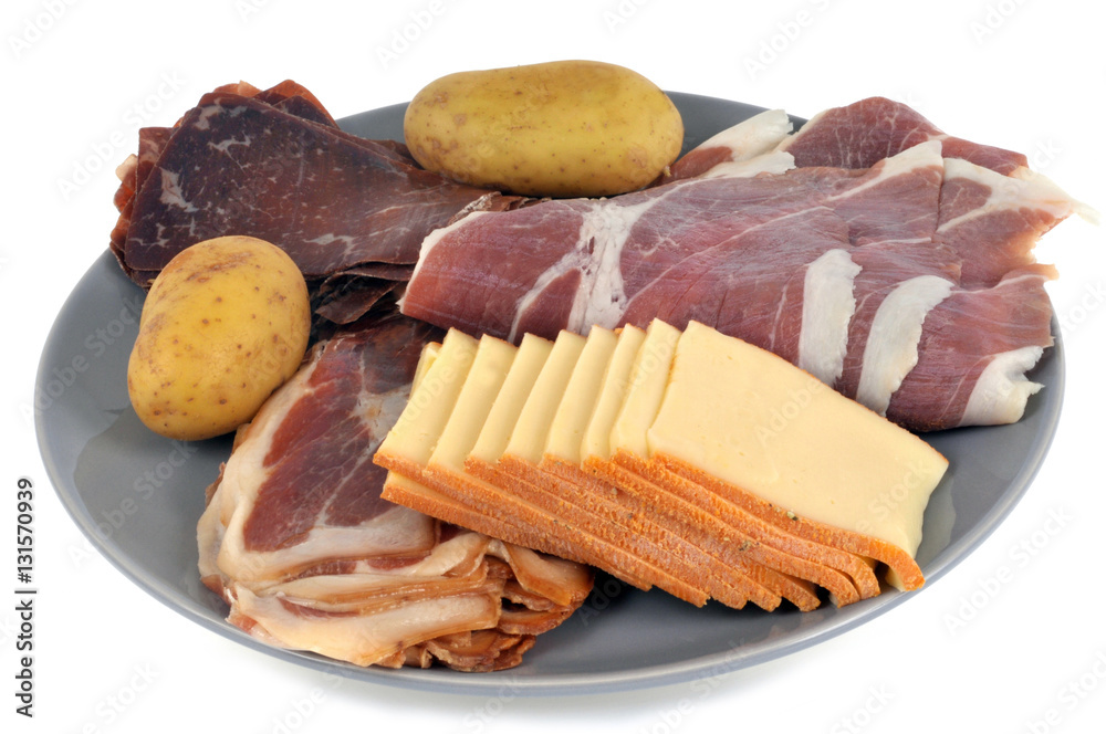 Assiette pour une raclette avec de la charcuterie, du fromage et des pommes  de terre Stock Photo | Adobe Stock