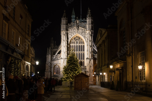People queue for Christmas Midnight Mass at Bath Abbey. Hundreds line up ahead of religious service to celebrate Christmas at Anglican Cathedral