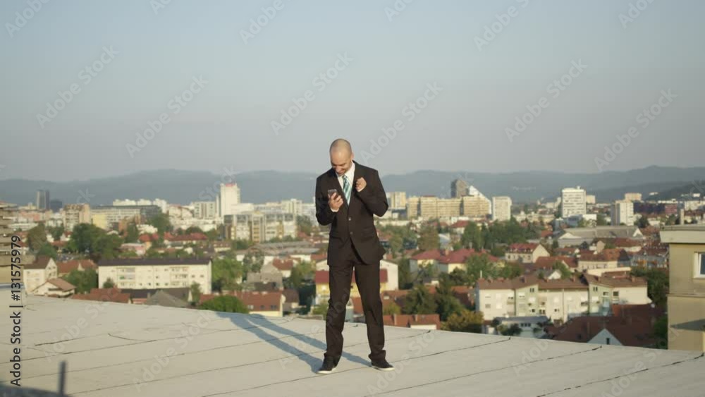 CLOSE UP: Businessman in suit jumping and celebrating the success on sunny day CLOSE UP: Businessman in suit jumping and celebrating the success on sunny day